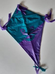 Ein blau-lila, selbstgebastelter Drache zum Hochsteigen lassen im Herbst